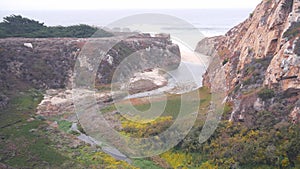 River creek estuary in canyon, mountain cliff or bluff. California ocean coast.