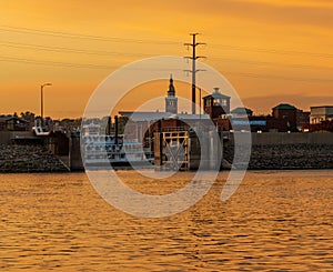 River cruise boat docked in Dubuque IA on colorful dusk evenign