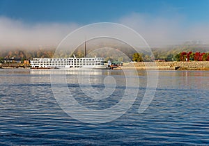 River cruise boat docked in Dubuque IA on misty autumn morning