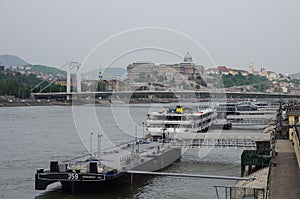 River Danube embankment, Buda Castle and bridge on background. B