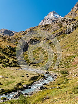 The river Dora di Rhemes flows across the valley of Rhemes; the peak called Granta Parey in the background Aosta Valley, Italy