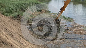 River Dredging Machinery Lifts Sand and Mud with Giant Shovel from River Bottom