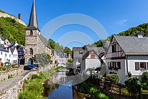 River elz with half-timbered houses and church in Monreal