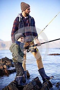 River, father and son with rod for fishing, water and nature for bonding of dad with boy together. Parent, male person