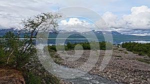 River flowing in Lake Tornetrask in Abisko National Park in Sweden