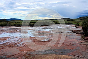 River flowing over red jasper rocks