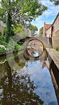 River flowing through small town next to bridge