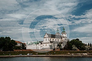 The river flows through the city. Church on the hill above the river. Wisla River in Krakow. Float the boat and the ship under wat