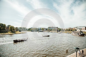 The river flows through the city. Church on the hill above the river. Wisla River in Krakow. Float the boat and the ship under wat