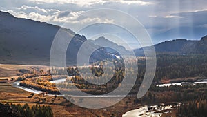 A river flows meandering along a picturesque valley