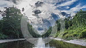 The river flows through a protected rainforest.