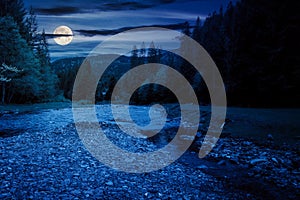 river flows through the valley of carpathian mountains at night