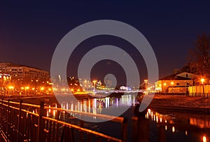 The river glows with lanterns by night