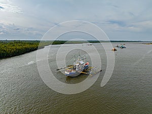 River going to the sea with fishing boats. Bislig, Surigao del Sur. Philippines.