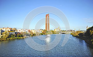 River Guadalquivir and the neighborhood of Triana with the Pelli Tower skyscraper in the background. Seville Andalusia Spain