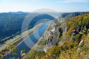 River between high banks with rocks in autumn in Germany