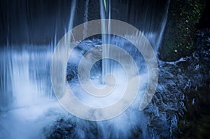 River during high water flow. Taken with a slow shutter speed to smooth out the flow of the water as is rushes by