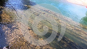 River with huge piece of rock mountain cliff stone at bottom