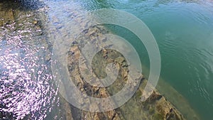 River with huge piece of rock mountain cliff stone at bottom