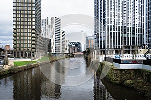 River Irwell running through the center of Manchester UK modern office and apartment building.