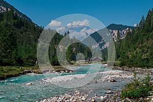 River Isar flowing through the Karwendel mountains during blue sky day in summer, Austria