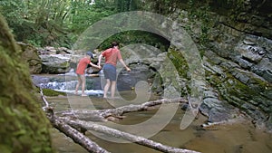 River in the jungle. CREATIVE. In the green jungle, two people are hustling and a river is flowing. In the foreground is