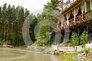 River Katun in Altai mountains, wooden terrace above river, beautiful forest