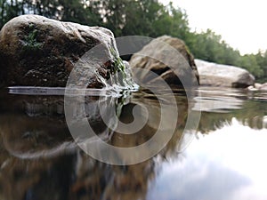 River, lake or the brook flowing in the wild nature.