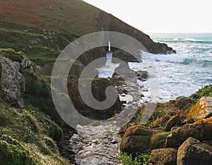 River Leads to a Sea Arch - Rugged Coast Cornwall, England