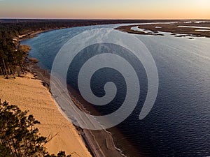 River Lielupe Coutnryside view in sunset near shoreline with beautiful pine tree forest