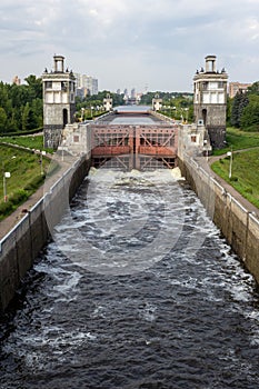 The river lock is filled with water to allow the ship to pass. Locks for vessels on the Moscow canal.