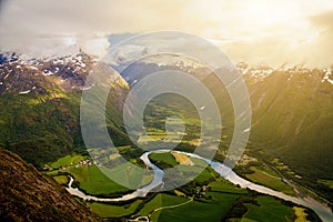 River meanders around fields seen from Romsdalseggen ridge, Andalsnes, Norway