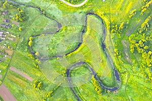 River meanders through national wildlife refuge, early summer aerial view