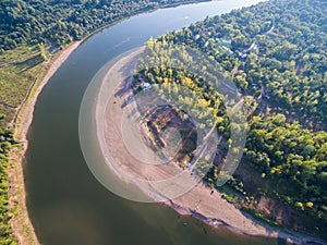 A river in the middle of a forest close to the city. Aerial survey of recreation center