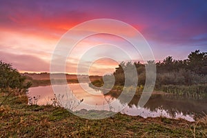 River misty autumn sunrise. Colorful dawn. Cloudy sunrise. Dusk fall colors