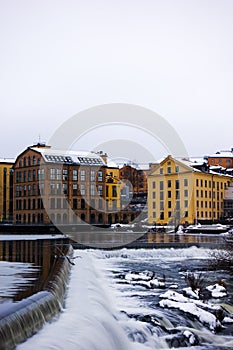 The river Motala Strom (Strommen) by old industrial buildings, a landmark of Norrkoping, Sweden in winter