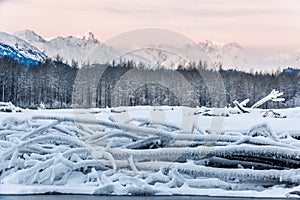 River and Mountains in snow on a sunrise.