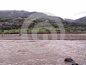 River near crops and trees photo