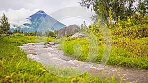 River near Mayon Volcano is an active stratovolcano in the province of Albay in Bicol Region, on the island of Luzon in photo