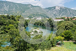 The river Neretva, the buildings and the mountains of Mostar city. Bosnia and Herzegovina.