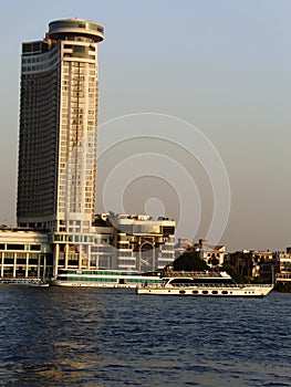 River Nile bank with a background of modern buildings on a sunny summer day and sailing boats, Cairo, Egypt