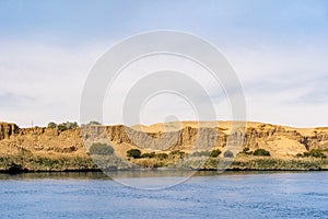 River Nile with it`s river banks full of vegetaion and the Sahara Desert close by