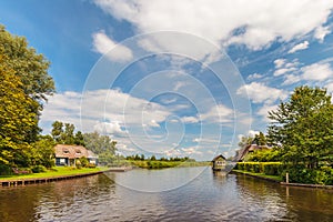 River with old houses in Dutch national park Weerribben