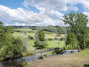 river ourthe occidentale in belgian ardennes region in summer under blue sky photo