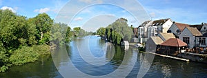 The river Ouse, Regatta meadows and riverside buildings at St Neots Cambridgeshire England.