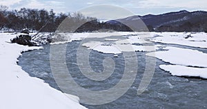 River passing through a mountain gorge in winter