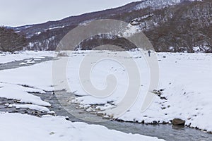 River passing through a mountain gorge in winter