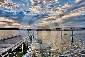 River pier at sunset, with dramatic cloudscape