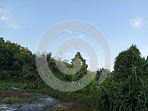 The beauty of the views of hills and rivers and trees against a blue sky background