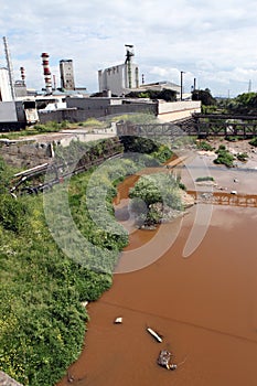 A river polluted with waste from a nearby factory